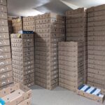Master shippers for produce containers stacked holding chocolate boxes.