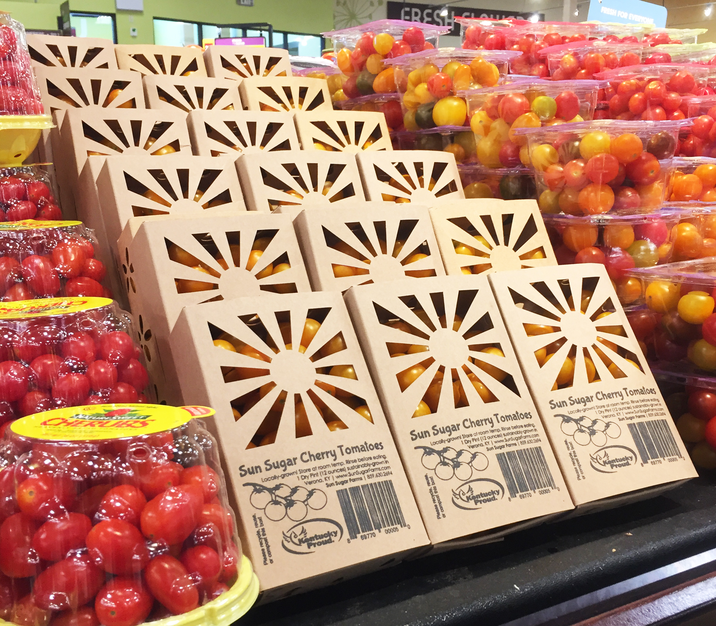 Cherry tomatoes in sustainable packaging in Kroger produce section.